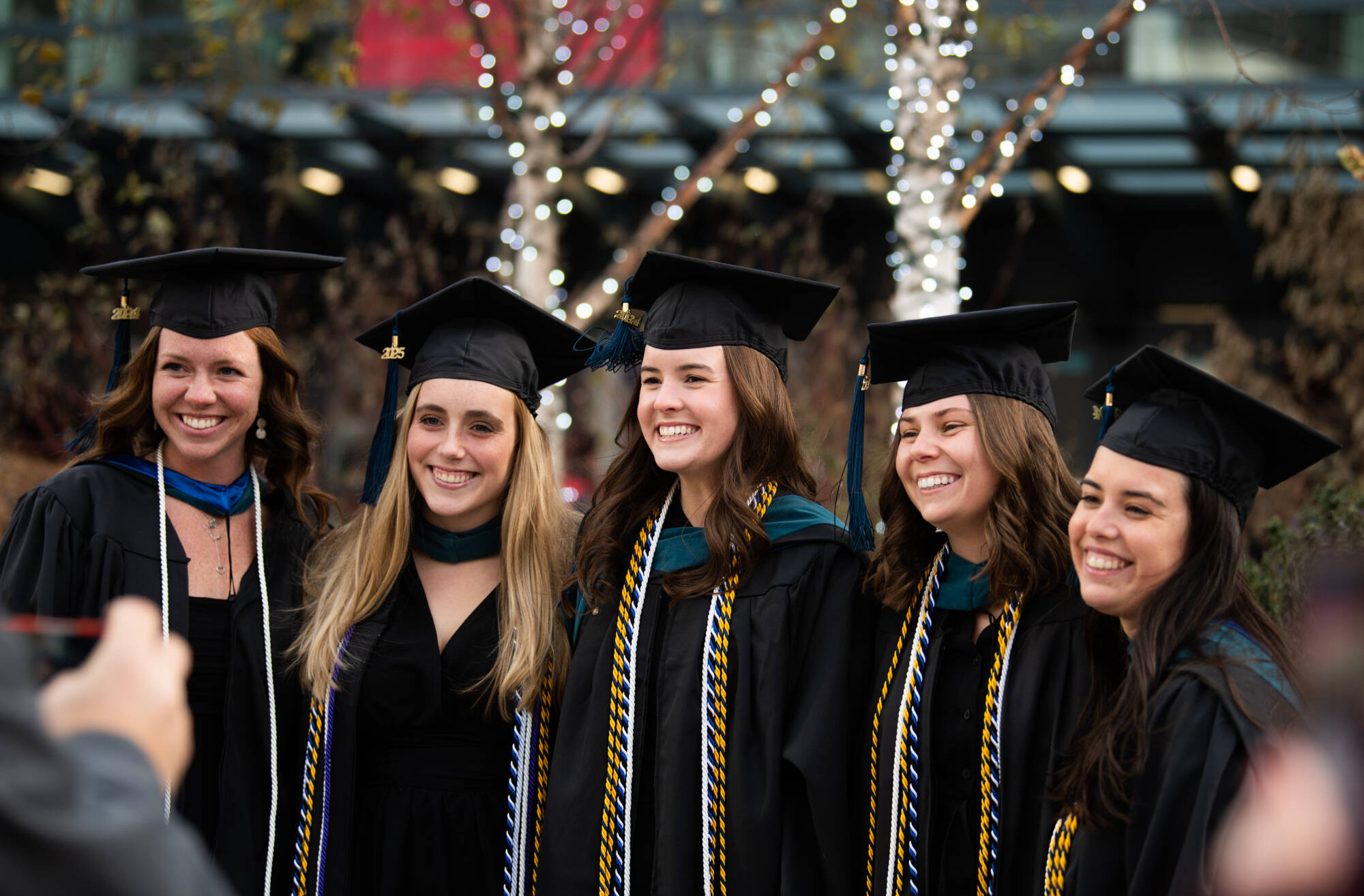 A group of master's smiling for a photo.